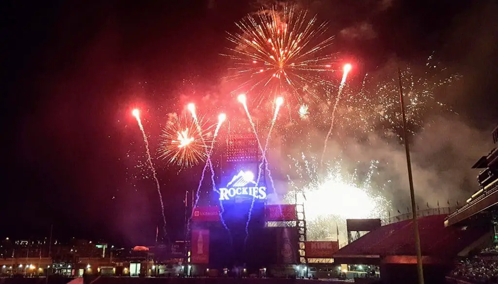 fireworks at coors field over the rockies sign