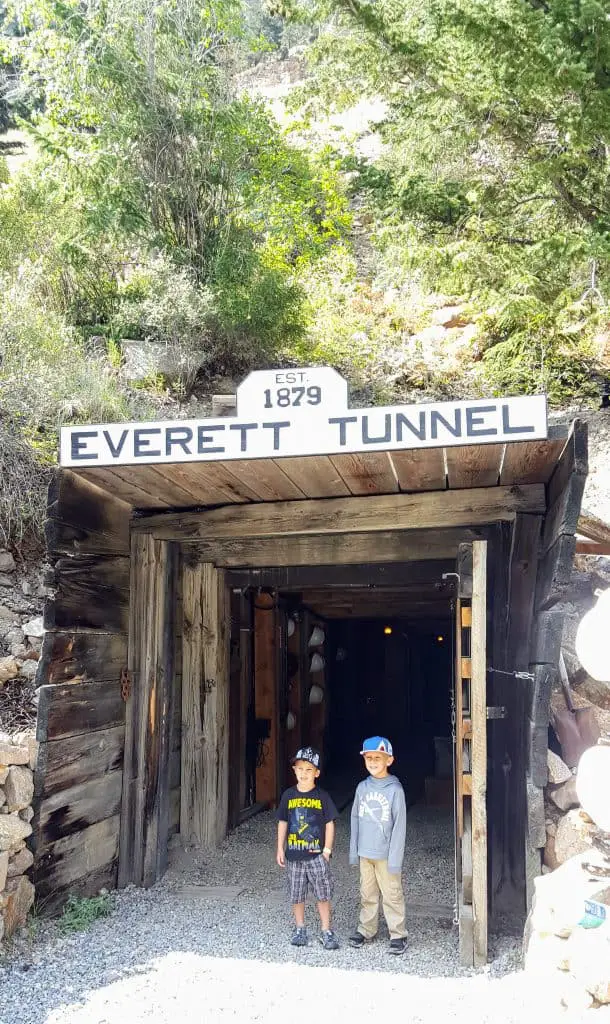 Two boys in front of the entrance to the Everett Mine. One of the gold mine tours in Colorado
