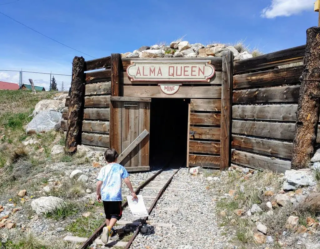 Eli walking into a mine in South Park City - Gold Mine Tours In Colorado