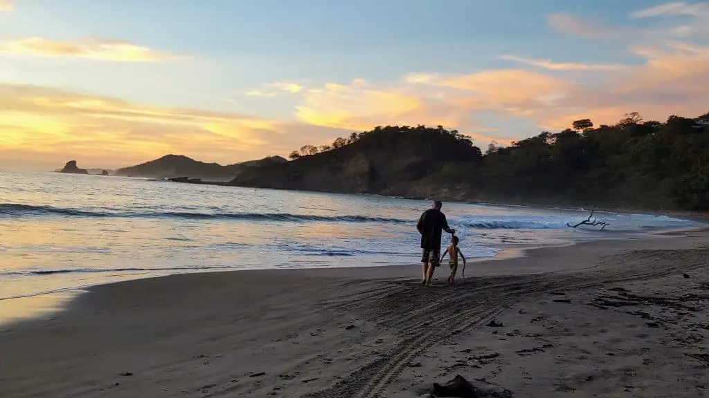 Chad and Eli walking on Playa Marsella in Nicaragua at sunset