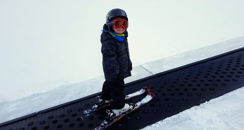 Eli on a magic carpet ski lift at Keystone ski resort