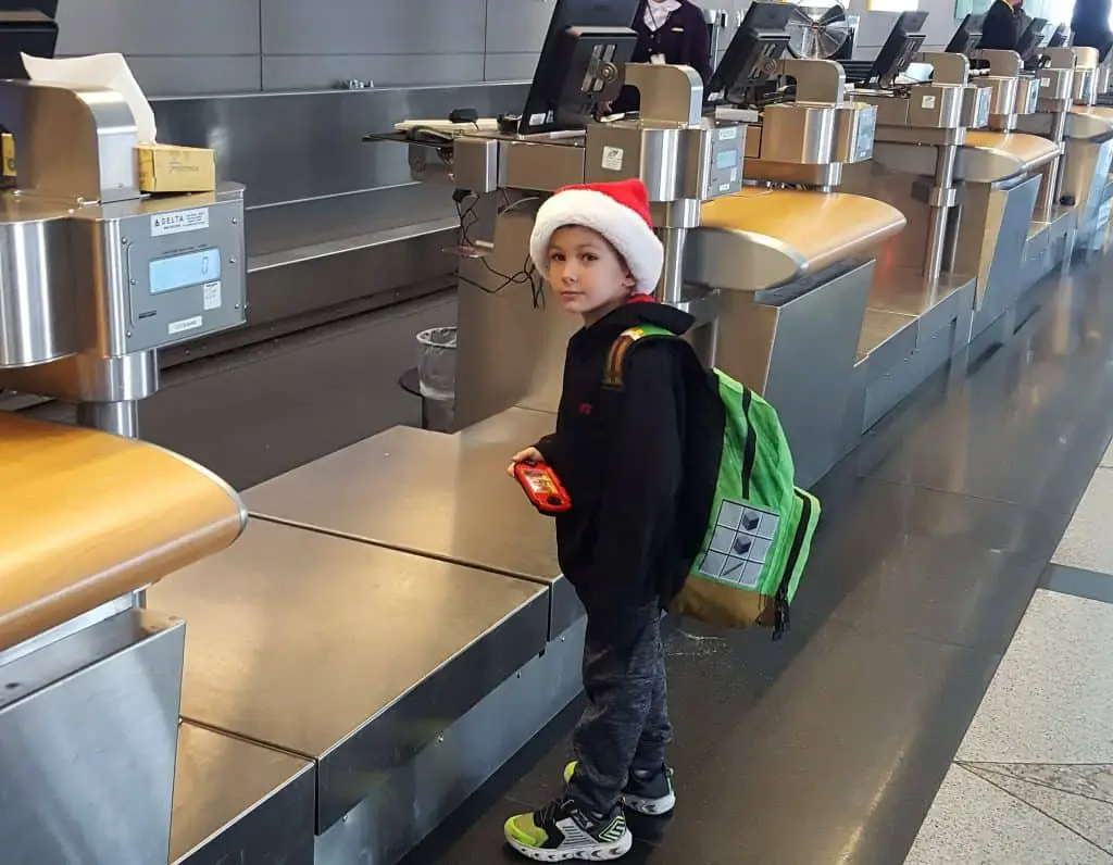 Boy at the Delta check in desk in Denver International Airport