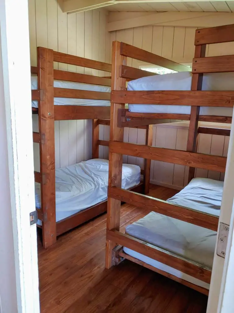 bedroom with two sets of bunkbeds in one of the Wai'anapanapa state park cabins