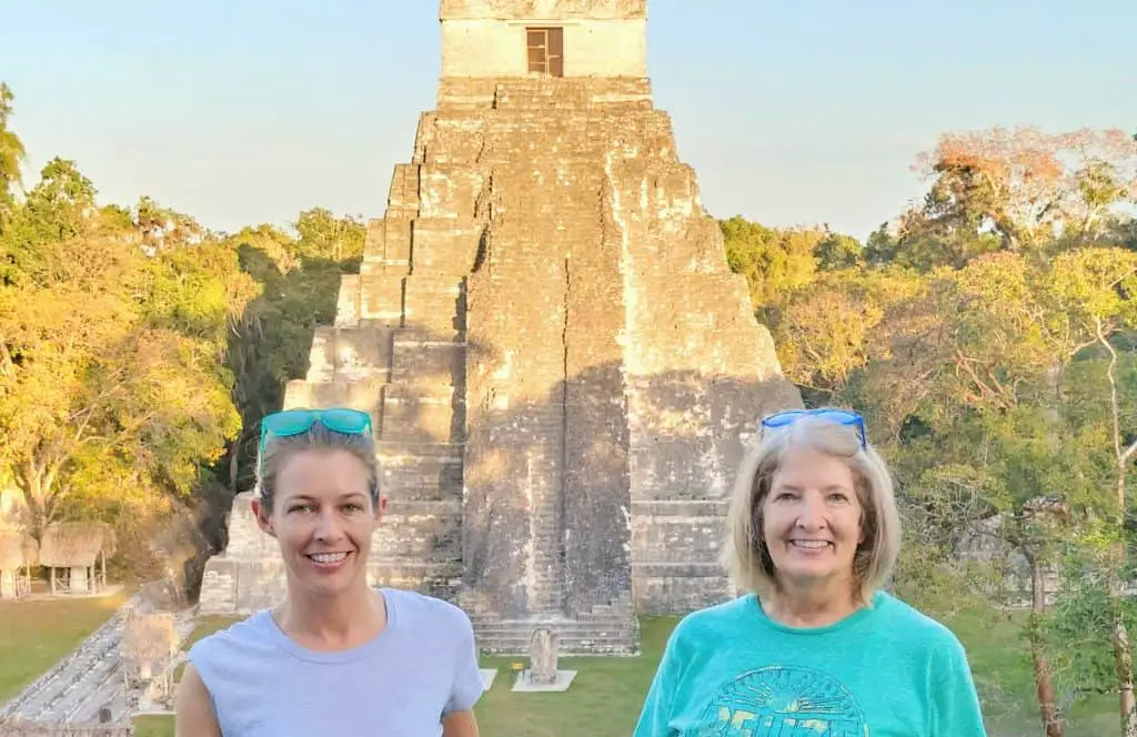 mom and daughter in front of a temple in tikal guatemala