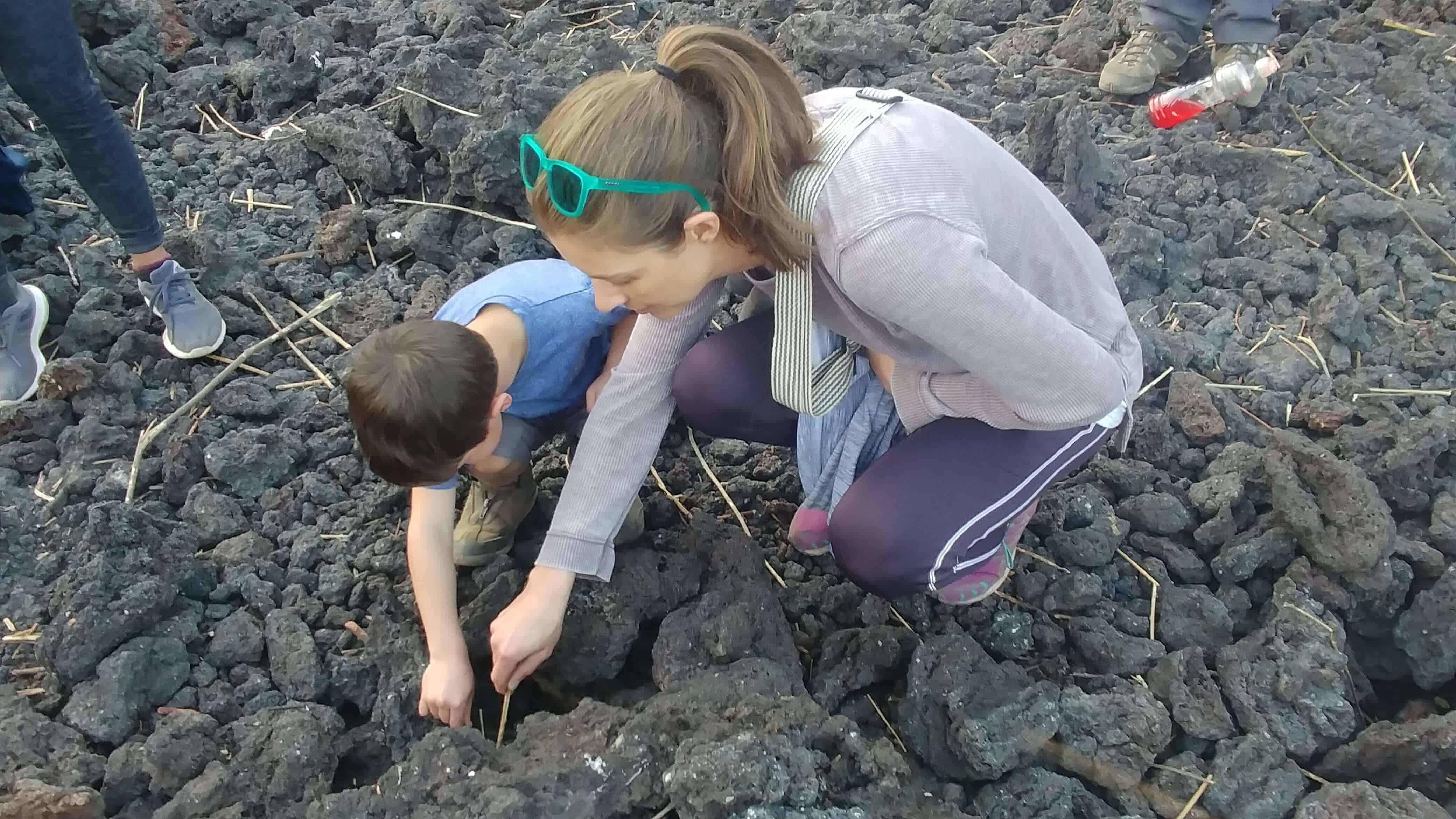 mother and son roasting marshmallows on a volcanic vent in Guatemala