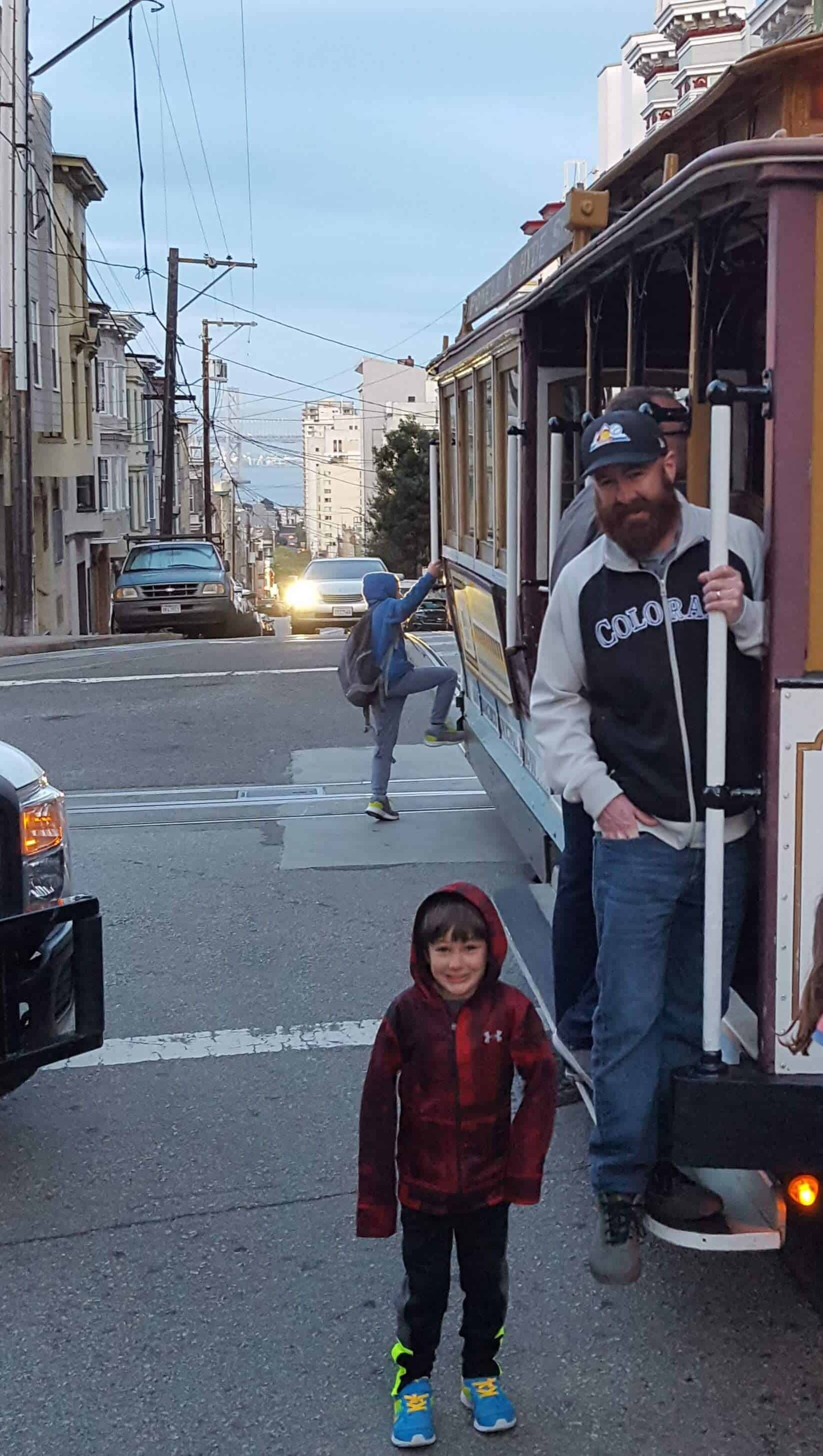 Eli and Chad standing next to the cable car on the way to Ghirardellil Square in San Francisco