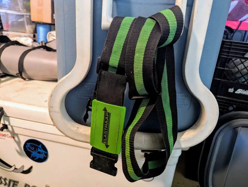 Luggage straps hanging from a cooler