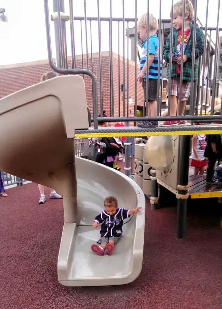 Eli on a slide at Dinger's Playground at Coors Field