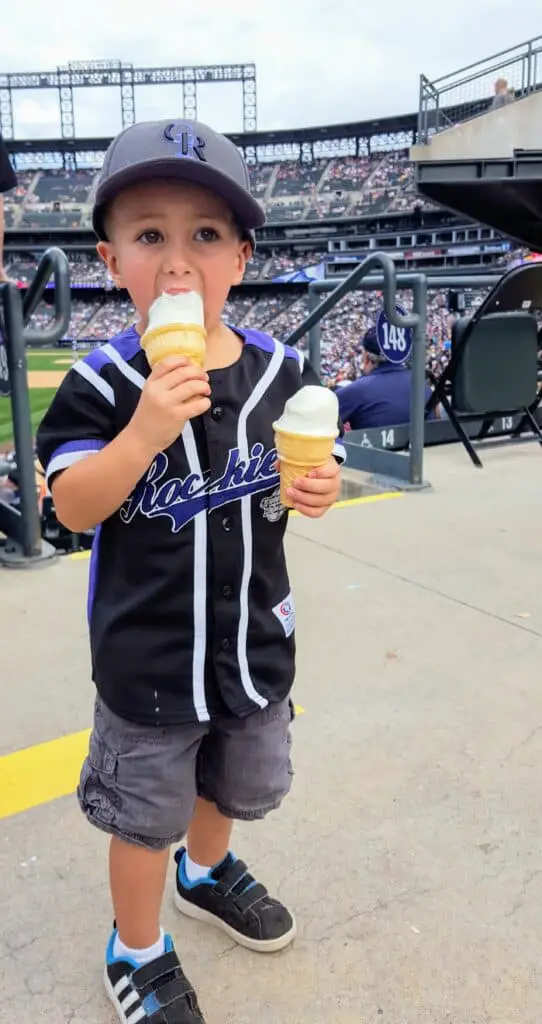 Eli eating a soft-serve ice cream cone at a rockies game
