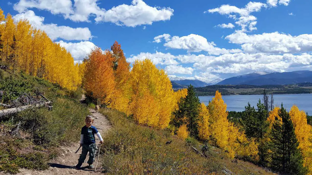 Boy hiking on the trail to Old Dillon Reservoir in Dillon, Colorado
