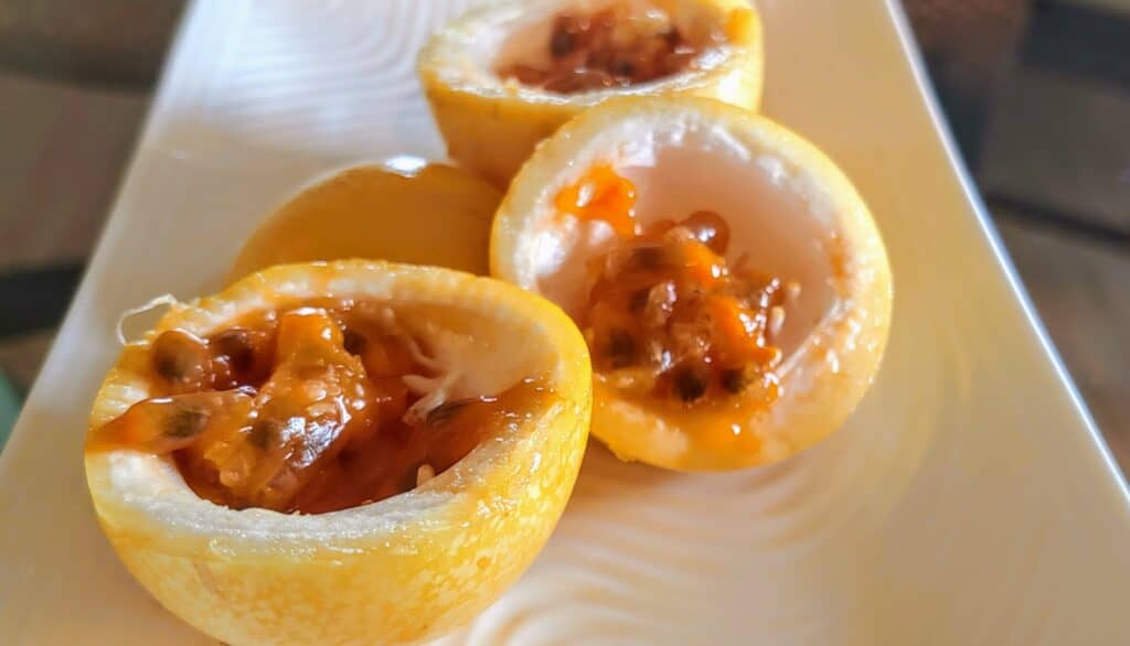 passion fruit cut up on a plate