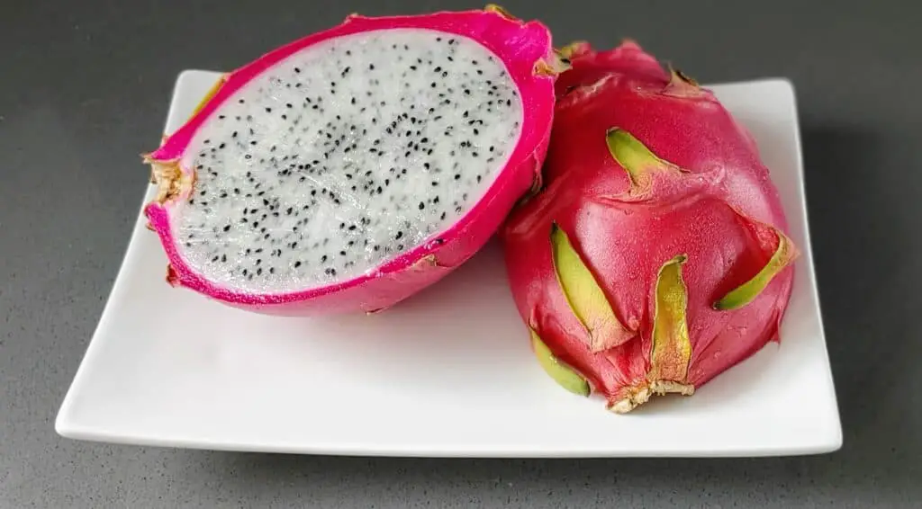 dragon fruit cut open on a plate