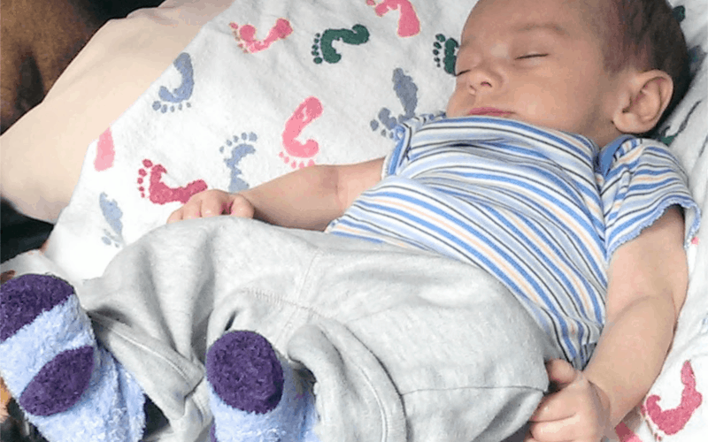Infant sleeping on a blanket