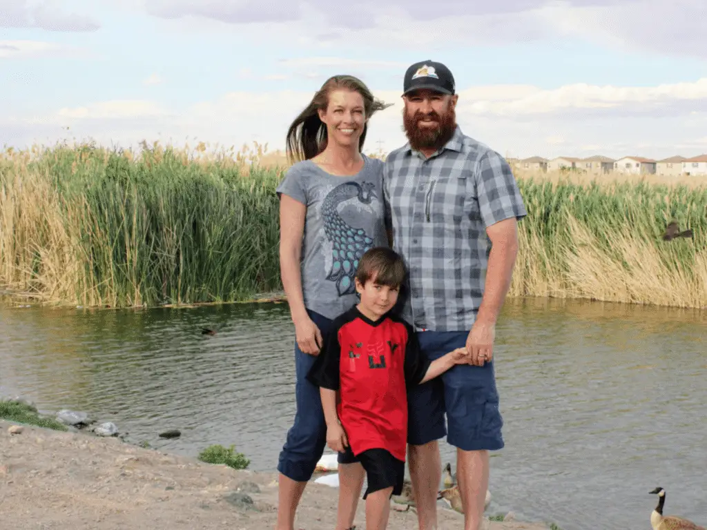 Family standing in front of a small lake in Las Vegas