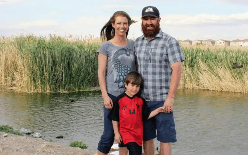 Family standing in front of a small lake in Las Vegas