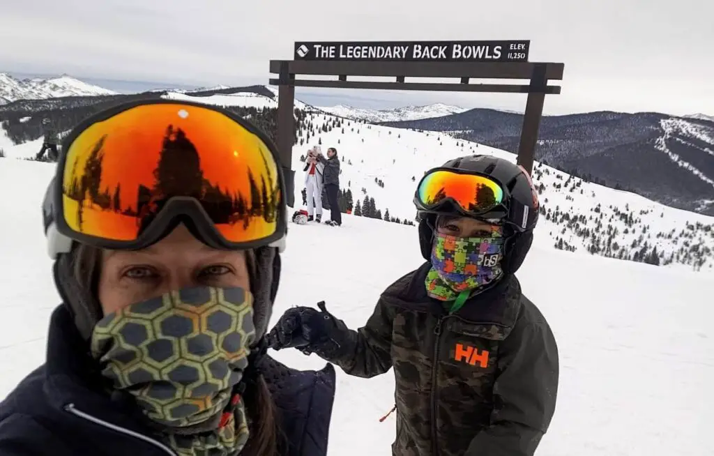 Mom and son standing in front of the back bowl sign at Vail Ski Resort