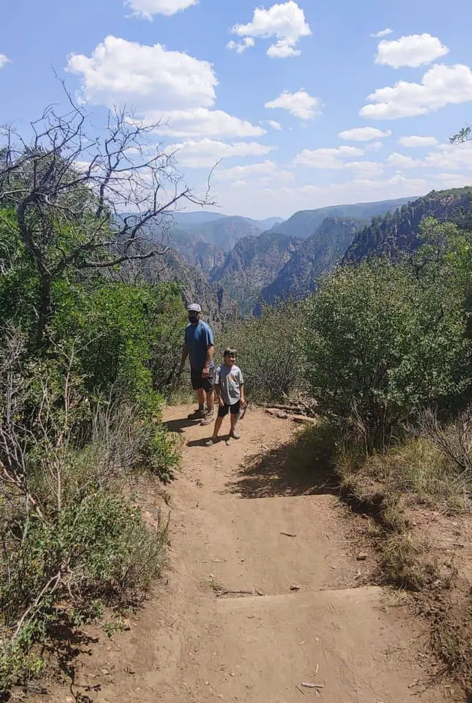 Father and Son hiking on a trail in Black Canyon of the Gunnison National Park in Colorado