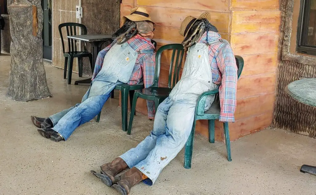Alligator heads on stuffed clothes sitting in a chair at Gator Park in the Everglades