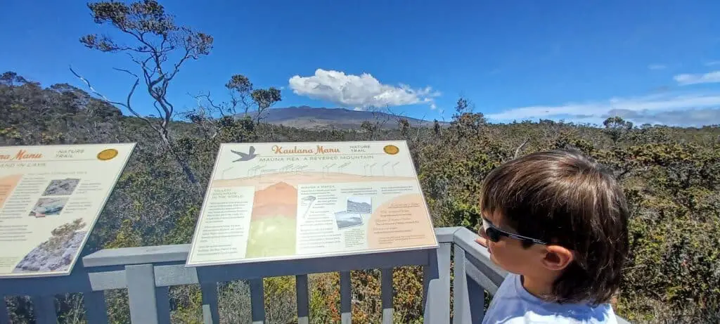 boy in front of a sign along Kaulana Nature Trail Big Island Hawaii
