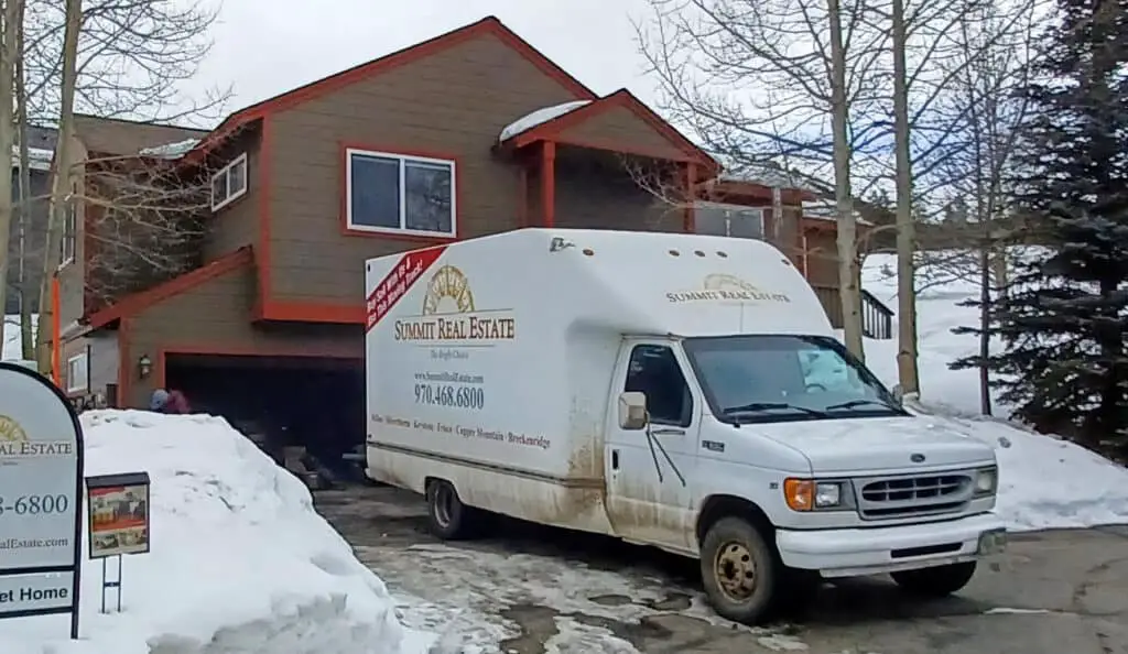 Moving Van in front of a house in the winter
