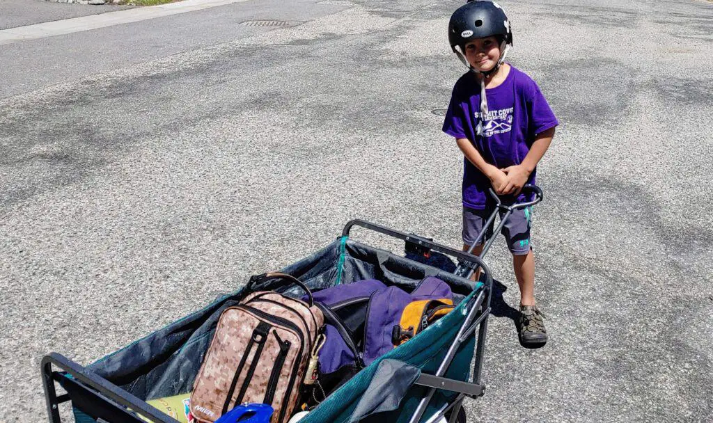 Boy pulling a wagon loaded with luggage