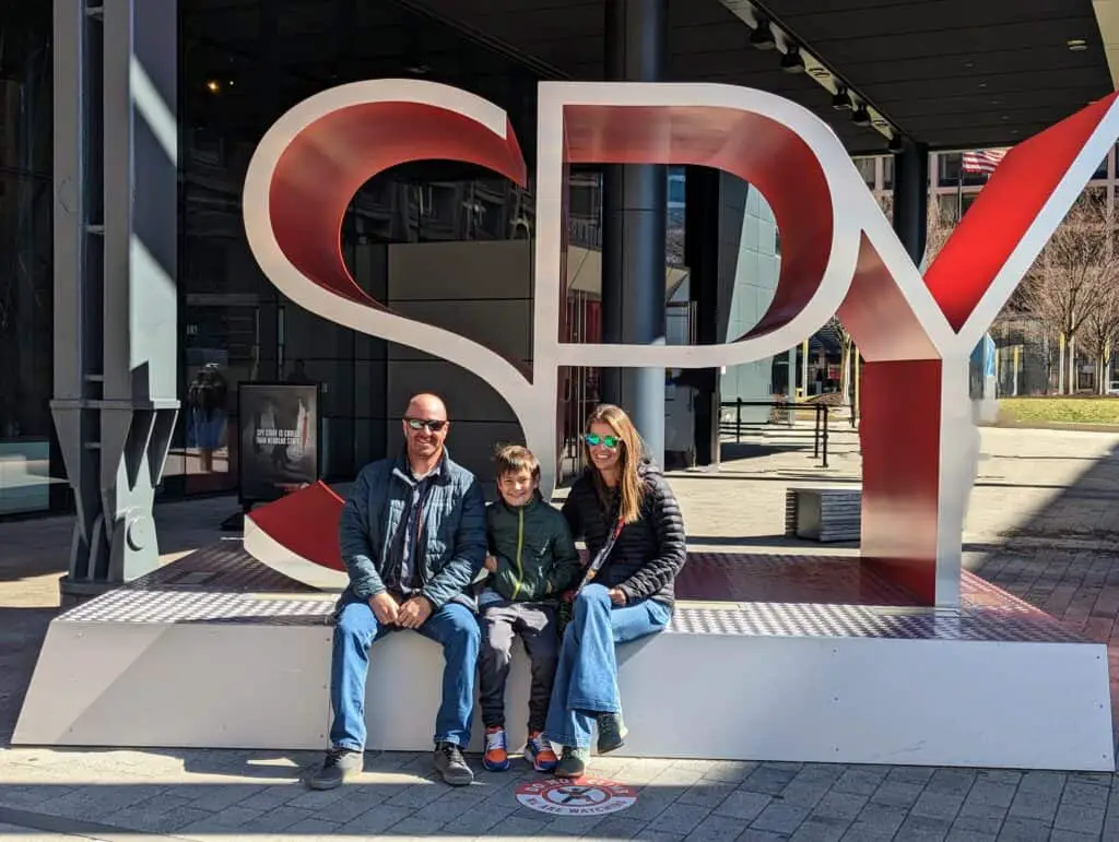 family in front of the spy museum in Washington DC