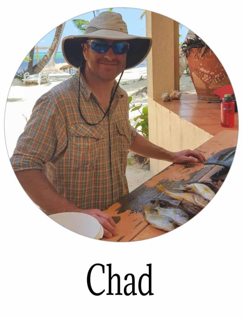 Chad's smiling face with fish on the table in front of him